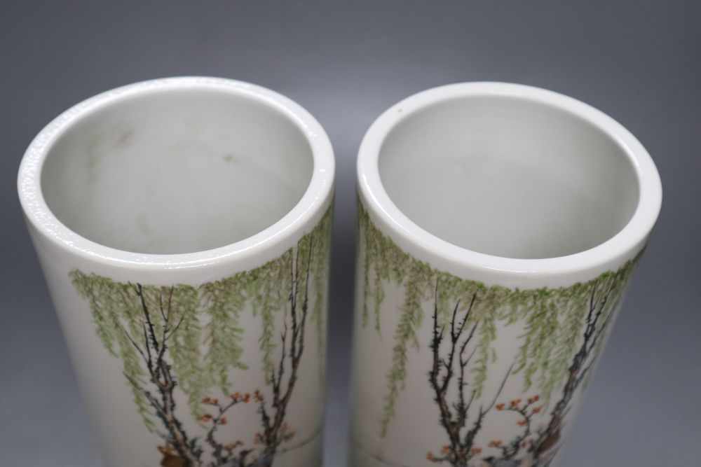 A pair of Chinese cylindrical porcelain vases, enamelled with fisherfolk, 29cm